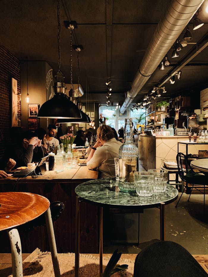 pexels-photo-3252051 Warm and inviting modern restaurant interior with people dining and intriguing decor, perfect for lifestyle imagery.